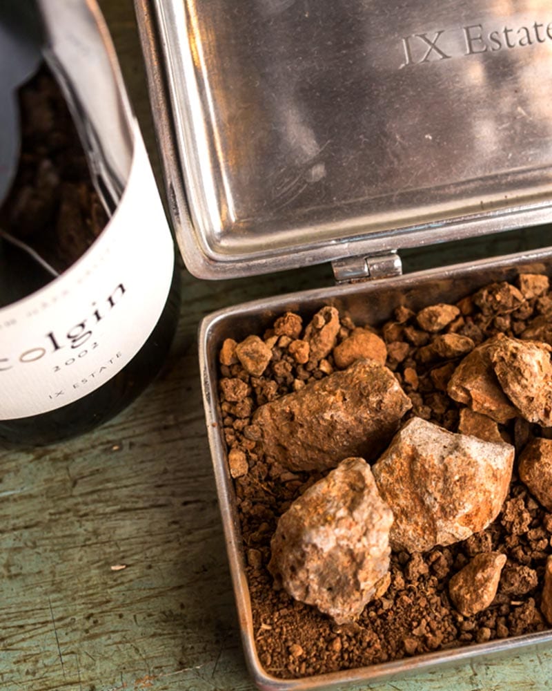 IX Rocks and Soil in Box next to Wine Bottle